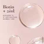 Billede af nogle dråber på en lyserød baggrund med overskriften: Biotin + Zink bidrager til at vedligeholde normalt hår